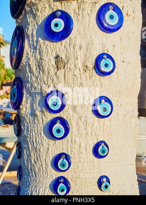 A lot of Nazar boncugu, a Turkish eye-shaped amulet screwed to a tree. Turkey. Stock Photo