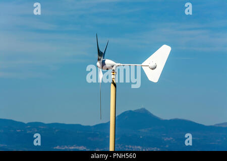 Micro wind turbine on the roof of a house, Puy de Dome department, Auvergne Rhone Alpes, France Stock Photo