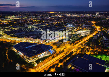 MUNICH, GERMANY - JULY 08, 2018: Aerial view of BMW Museum and BWM Welt and factory and Munich from Olympic Tower illuminated at night. BMW is a famou Stock Photo