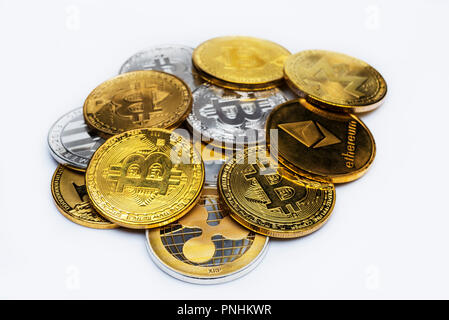 A bunch of Gold bitcoin currency tokens isolated on a white background, a set of different bitcoin coins. Stock Photo