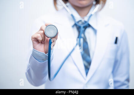 woman doctor holding blue stethoscope and show stethoscope diaphragm with white background Stock Photo