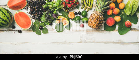 Seasonal fruit, vegetables and greens over wooden background, wide composition Stock Photo