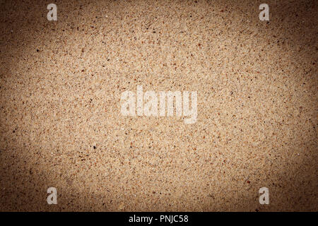 Bright fine-grained sandy texture, background with darkened vignette Stock Photo