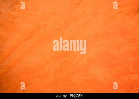 Jersey bright orange fabric with light folds closeup, may be used as background or texture Stock Photo