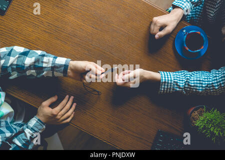 overhead top view of two casual businessmen work in the office at the table workplace, toned Stock Photo