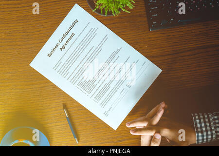 partnership agreement business document signed by a person on the table in office Stock Photo