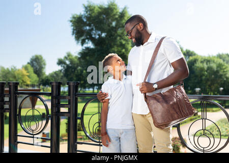 Positive nice handsome man looking at his son Stock Photo