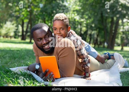 Positive joyful man holding a new tablet Stock Photo