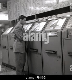 1948, historical, an overseas male visitor from the commonwealth on the London underground buying a ticket for zone 2, from the coin-operated ticket machines, London, Engalnd, UK. Stock Photo