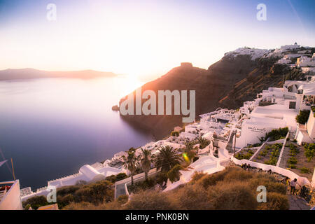 Santorini , Greece- June 11, 2016: Overlooking the hotel terrace with a table and chairs at famous sunset in Santorini, Greece, Stock Photo