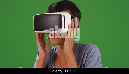 Black female using virtual reality headset on green screen Stock Photo