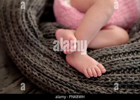 the mother's hand holds legs. Stock Photo