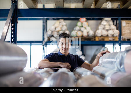 Portrait of male employee in distribution warehouse Stock Photo