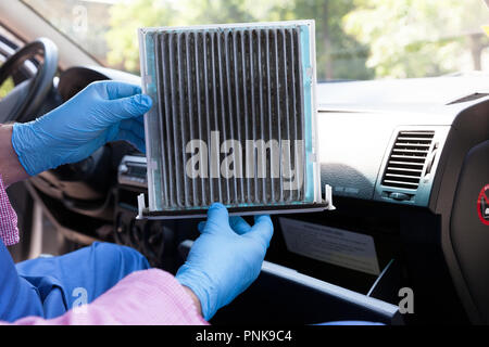 https://l450v.alamy.com/450v/pnk9c4/auto-mechanicwearing-protective-blue-gloves-showing-dirty-car-cabin-air-filter-old-car-cabin-pollen-filter-replacement-pnk9c4.jpg