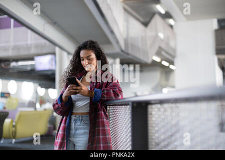Female student looking at smartphone in high school Stock Photo