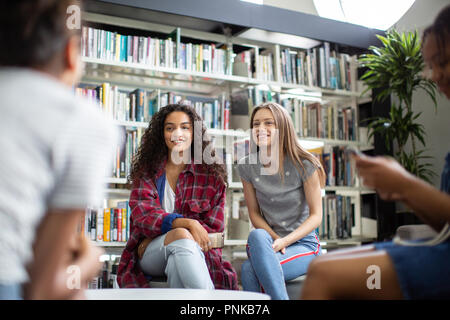 High school students studying together in a library Stock Photo
