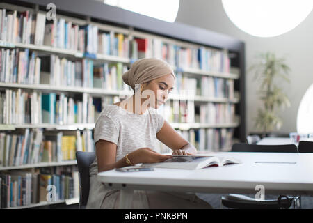 Muslim female student in college library Stock Photo