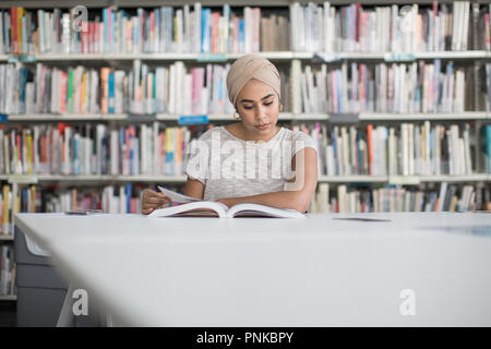 Muslim female student in college library Stock Photo