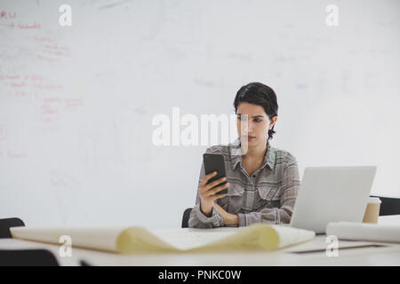 Arabic businesswoman using a smartphone in office Stock Photo