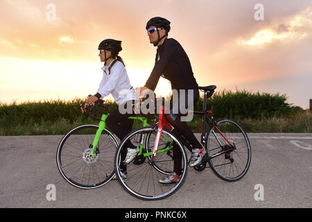 a couple of cyclists stopped on the road Stock Photo