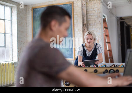 Young adult female using digital tablet in a creative office Stock Photo