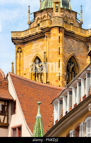 View of the 'St. Martin's Church' Cathedral and old half-timbered houses with colorful window shutters in the beautiful old French town of Colmar in A Stock Photo