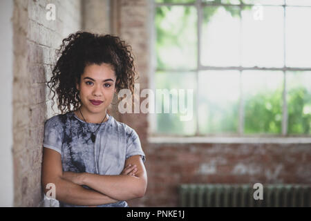 Portrait of millennial female in creative office Stock Photo