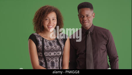 Black man and woman professionals smiling at camera on green screen Stock Photo