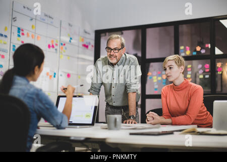Coworkers working late in an office Stock Photo