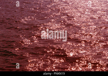 red tone, background water surface, ripple on the water Stock Photo