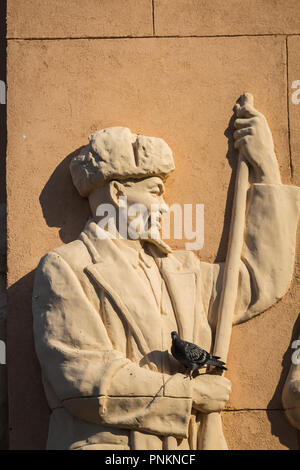 Moscow, Russia - July 21, 2018 - statue of Kazakh shepherd on a wall of a pavillion in VDNKh exibition park Stock Photo