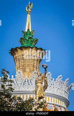 Moscow, Russia - July 21, 2018: pavilion of VDNKH. Pompous, with the old symbols of the Soviet Union, decorated with gold spire, and sculptures Stock Photo