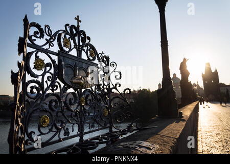 Decorative lattice with John of Nepomuk bronze statue on Charles Bridge, Prague, Czech Republic, sunny day Stock Photo