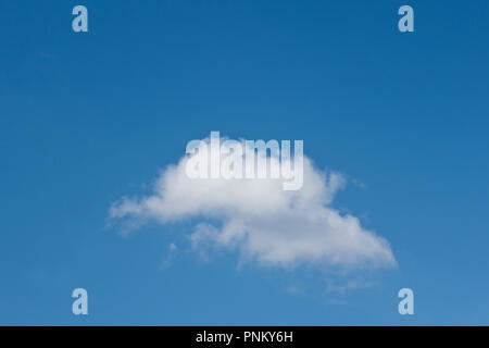 single cumulus white cloud on a blue sky Stock Photo