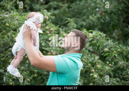 Belarus, Gomel, on July 14, 2018. A holiday in the village of Zyabrovka. Father throws a newborn baby Stock Photo