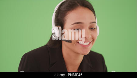 Hispanic woman customer service call center representative on green screen Stock Photo