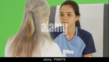 A concussed soccer player seeks help on green screen Stock Photo