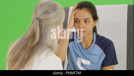 A concussed soccer player seeks help on green screen Stock Photo