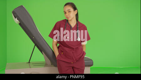 A nurse poses for a portrait on green screen Stock Photo