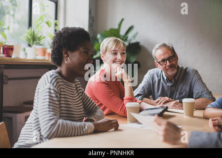 Group of coworkers having a meeting in a cafe Stock Photo