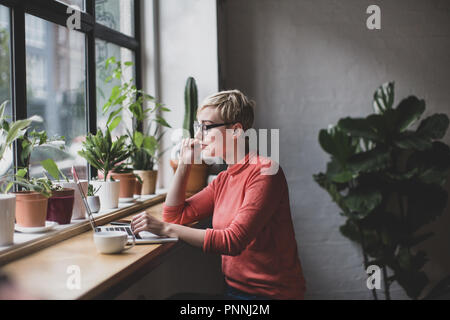 Freelance businesswoman working in a cafe Stock Photo