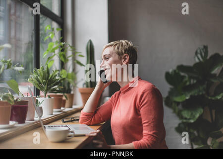 Freelance businesswoman working in a cafe Stock Photo