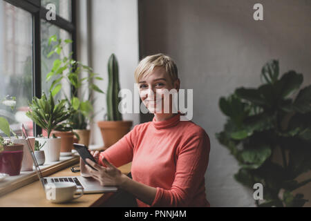 Portrait of a freelance businesswoman working in a cafe Stock Photo
