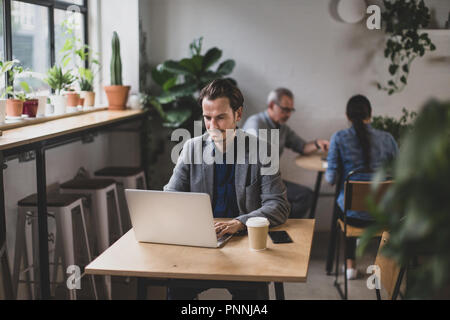 Freelance businessman working in a cafe Stock Photo