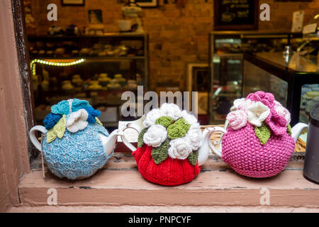 Coloured teapots sitting on a window frame Stock Photo