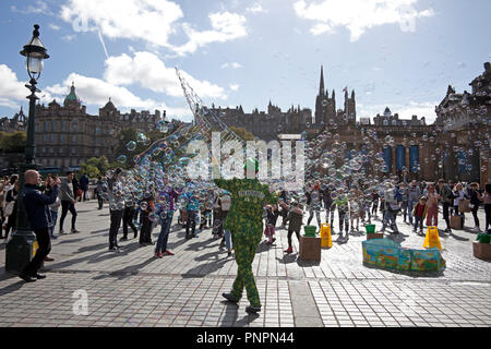 Edinburgh, Scotland, UK, 22 September 2018. Weather, in the autumn sunshine with 14 degrees Mr Freakbubbles entertains children and adults alike with his bubble show at the Mound and Edinburgh Lindy Exchange hold their Annual Swing Dancing Festival where members and audience participate and enjoy the experience. While others chose the less energetic lazing in Princes Street Gardens East. Stock Photo