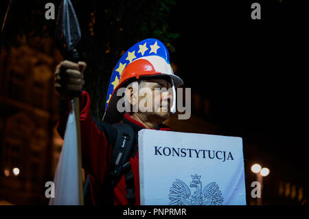 Krakow, Poland. 22nd Sep, 2018. A man seen with a handmade roman helmet with EU flag stars and Polish flag colors and a spear during the protest.Protest called ''We have the right to free courts'' at the main Square.The European Network of Councils for the Judiciary (ENCJ) has suspended the Polish council membership because it's no longer being independent because it is now appointed by politicians, rather than judges as before. The European Commission decided this week to take Poland to the top European Union court over the controversial court reforms. (Credit Image: © Omar Marques/ Stock Photo
