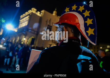 Krakow, Poland. 22nd Sep, 2018. A man seen with a handmade roman helmet with EU flag stars and Polish flag colors during the protest.Protest called ''We have the right to free courts'' at the main Square.The European Network of Councils for the Judiciary (ENCJ) has suspended the Polish council membership because it's no longer being independent because it is now appointed by politicians, rather than judges as before. The European Commission decided this week to take Poland to the top European Union court over the controversial court reforms. (Credit Image: © Omar Marques/SOPA Images Stock Photo