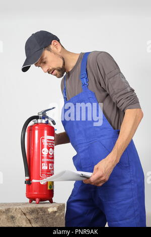 A Fire extinguisher check by a professional Stock Photo