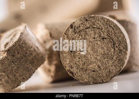 Close-up wooden pressed briquettes from biomass. Stock Photo